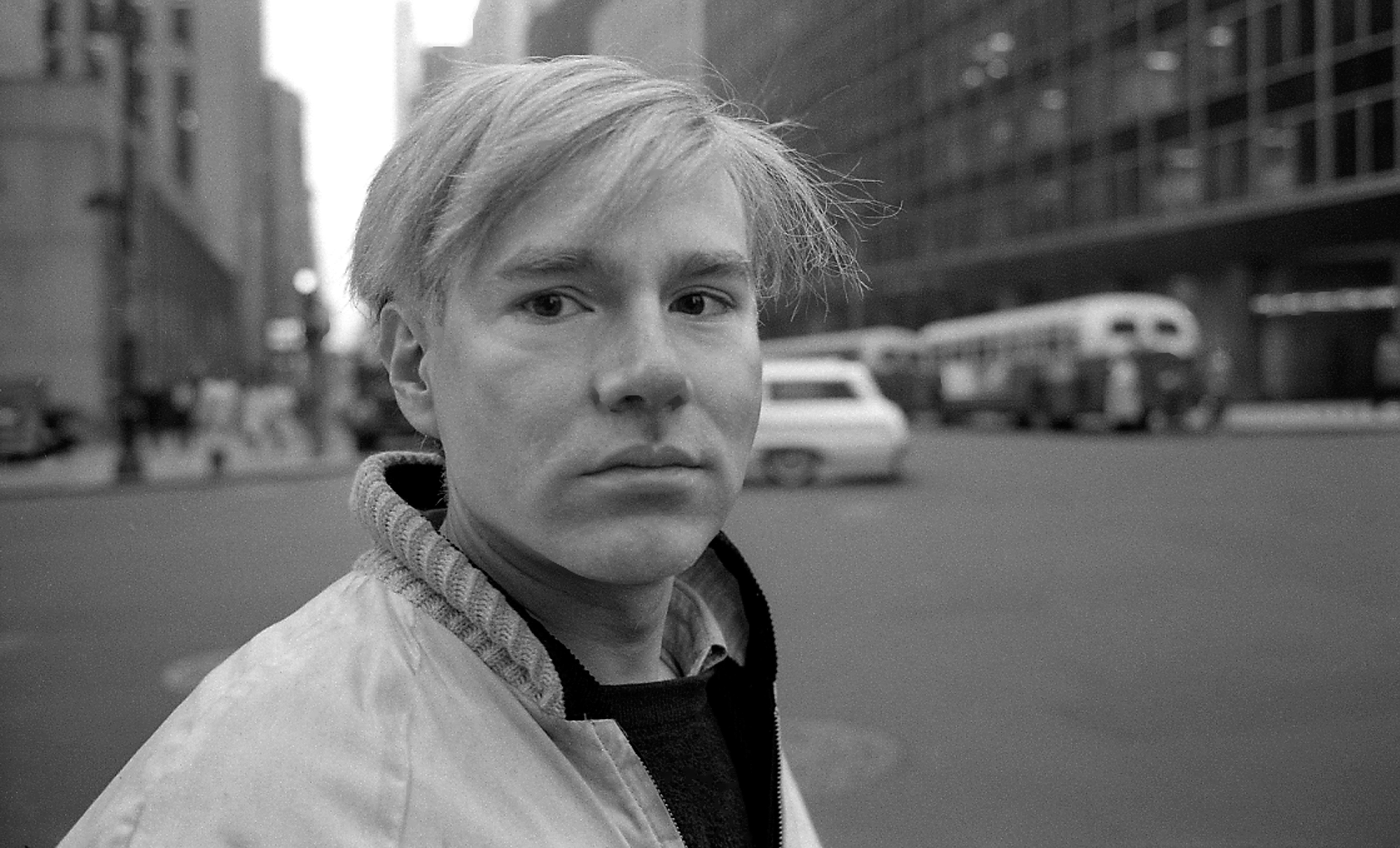 a black and white photo of a man in a white jacket