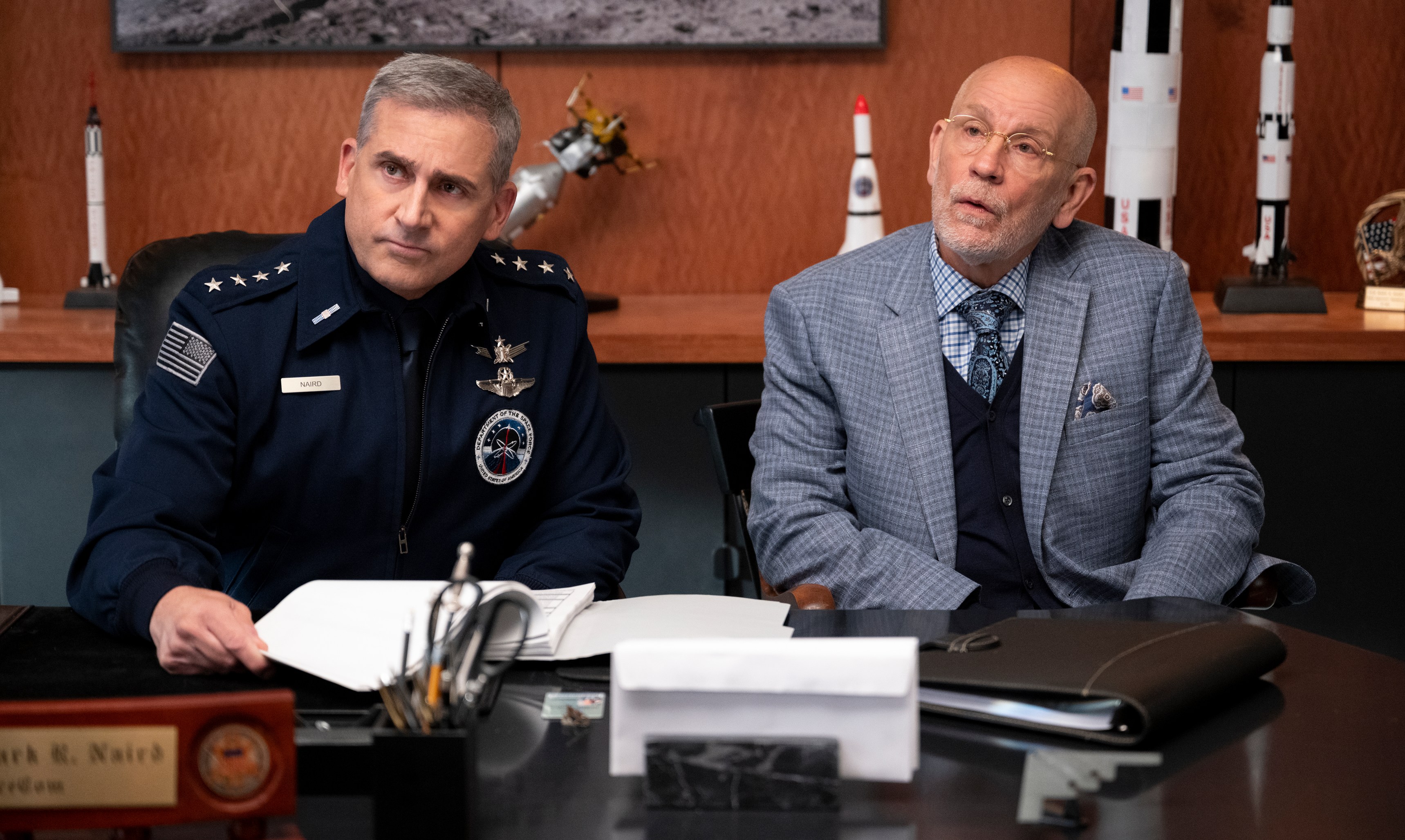 two men sit at a desk with a name plate that says jack r. wright