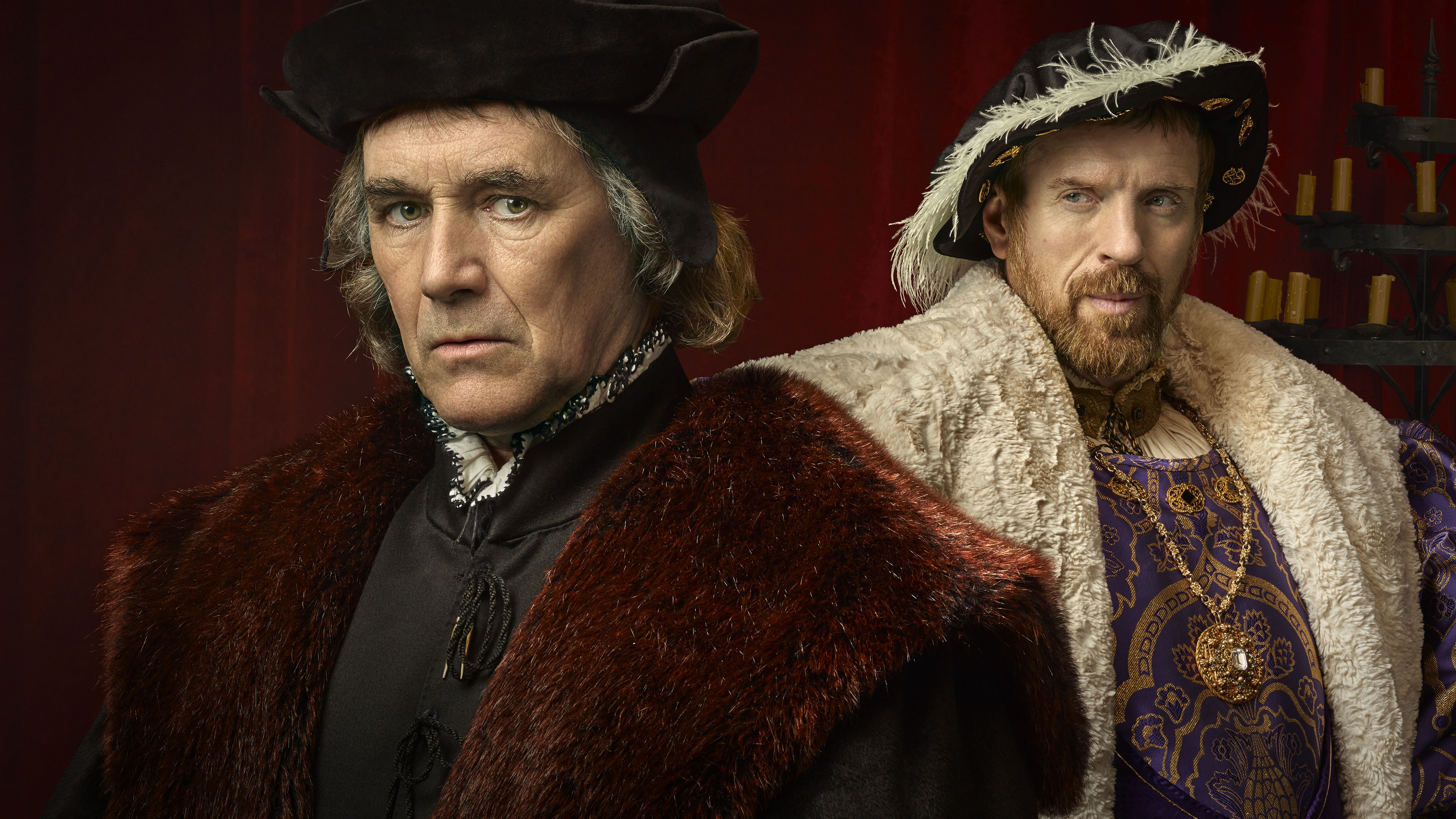 two men standing next to each other with one wearing a fur coat