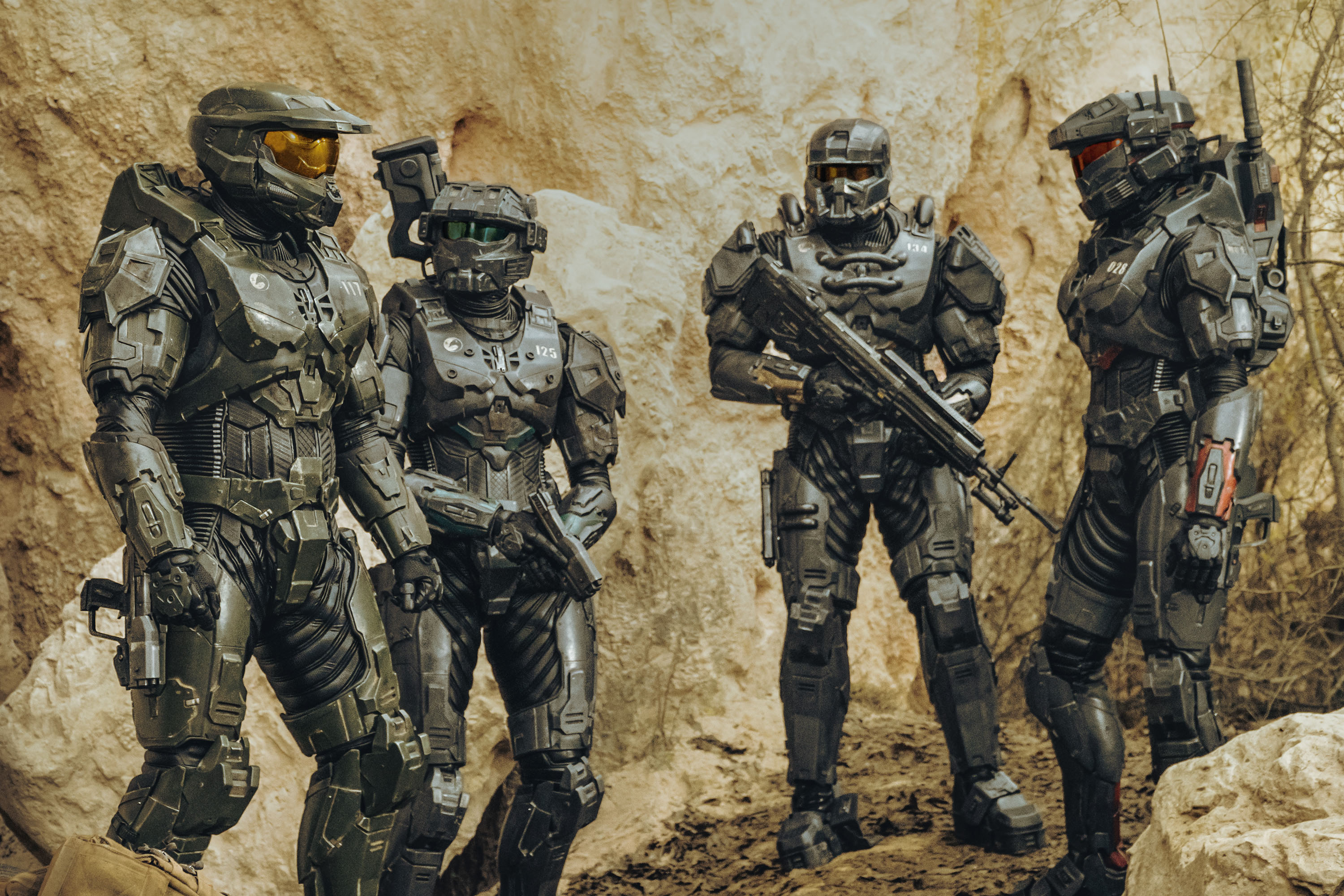 a group of soldiers are standing next to each other with one of them wearing a helmet with the letter c on it