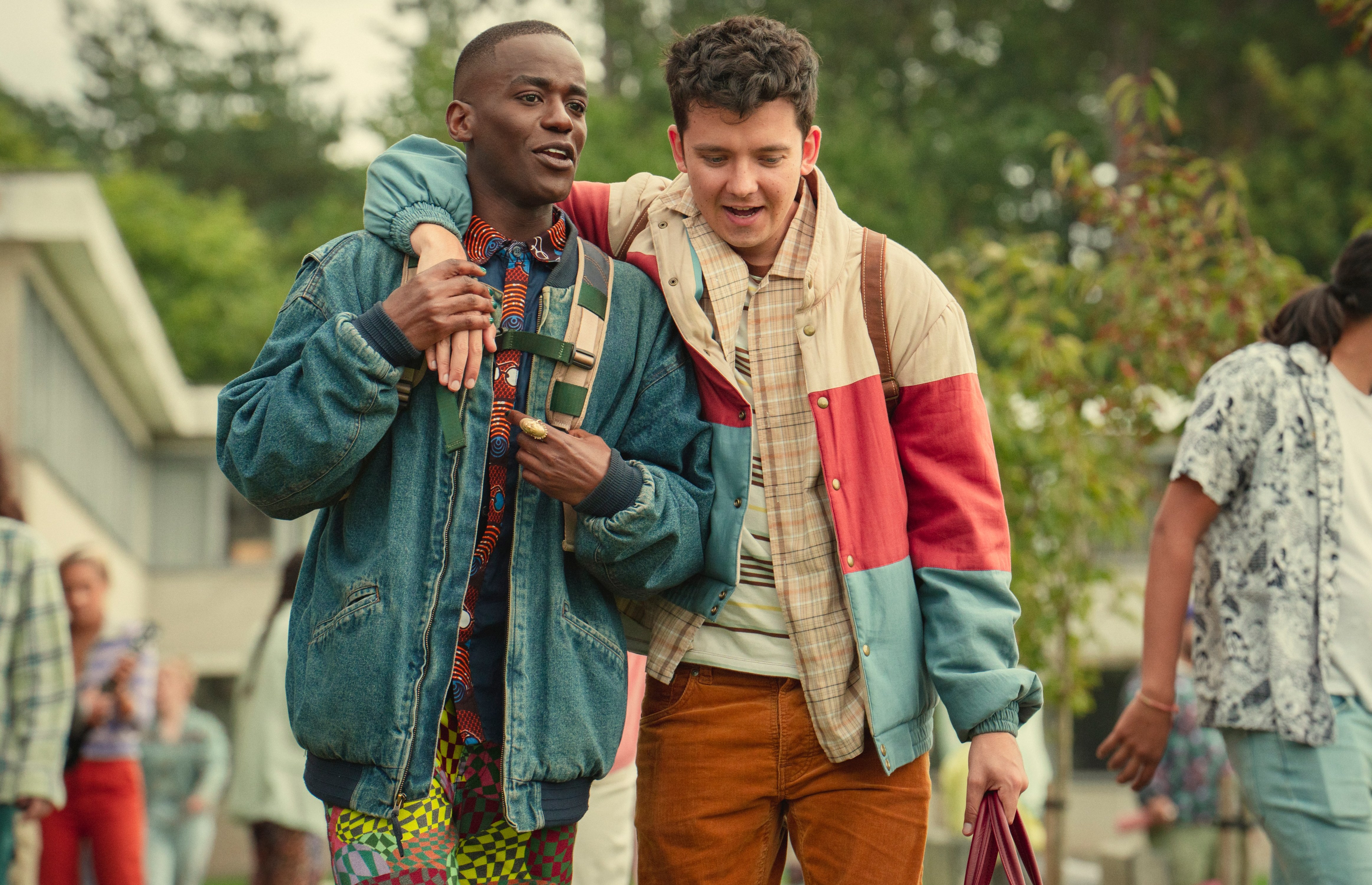 a man in a denim jacket has a ring on his finger