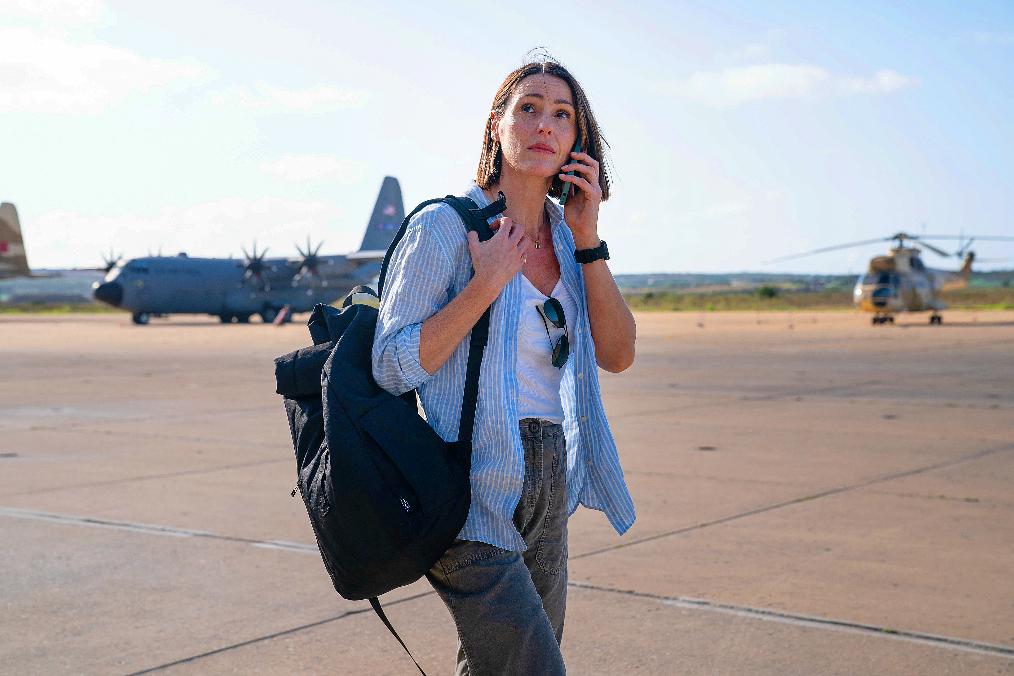 a woman with a backpack talking on a cell phone