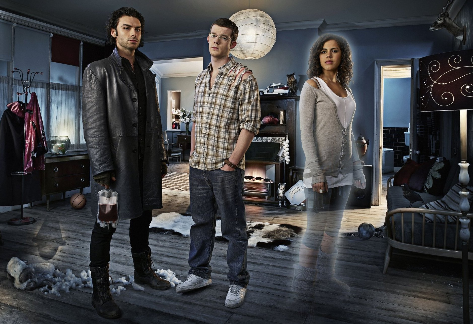 three people standing in a living room with a ghost in the background