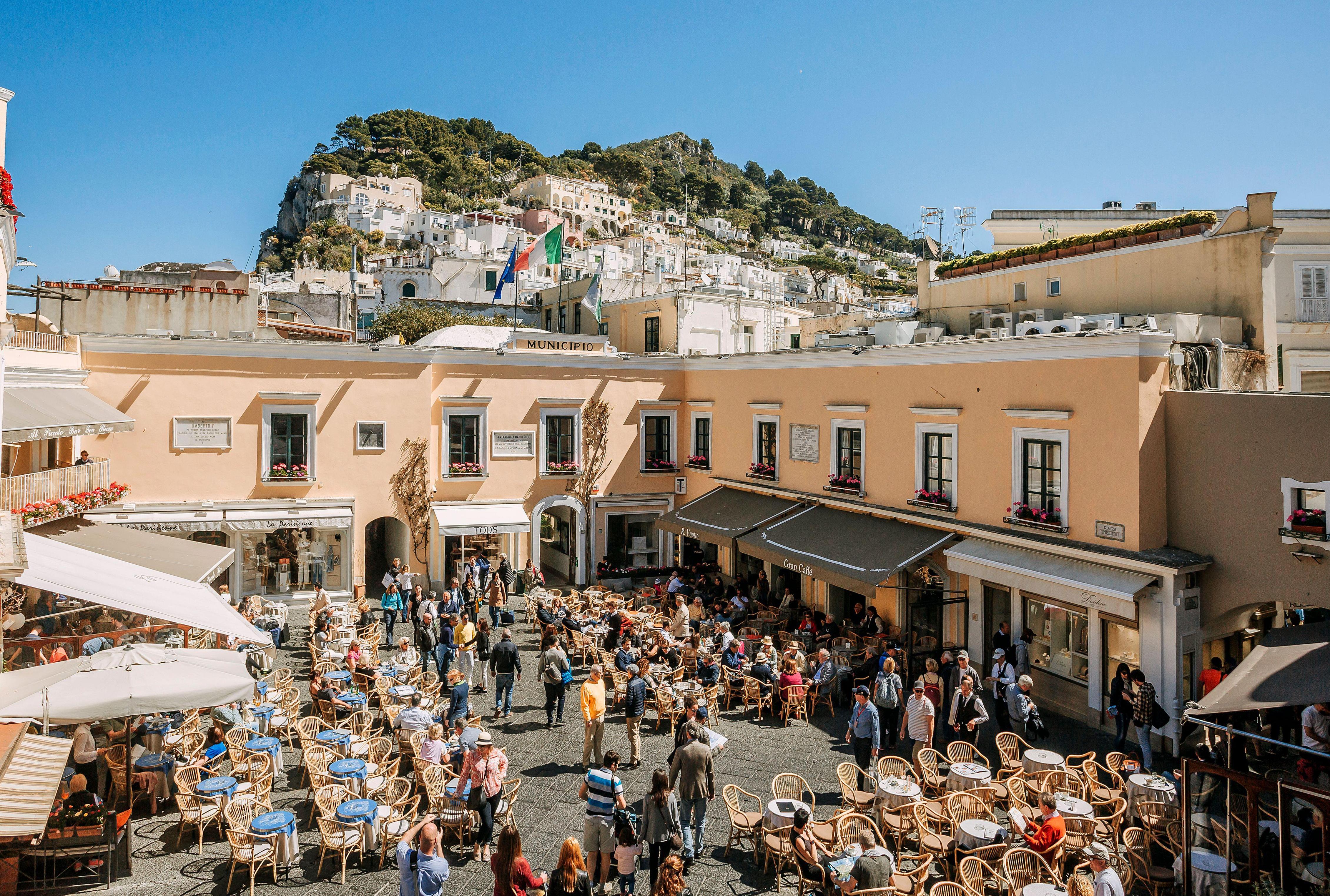 Capri's Piazzetta square, filled with people at outdoor cafes.