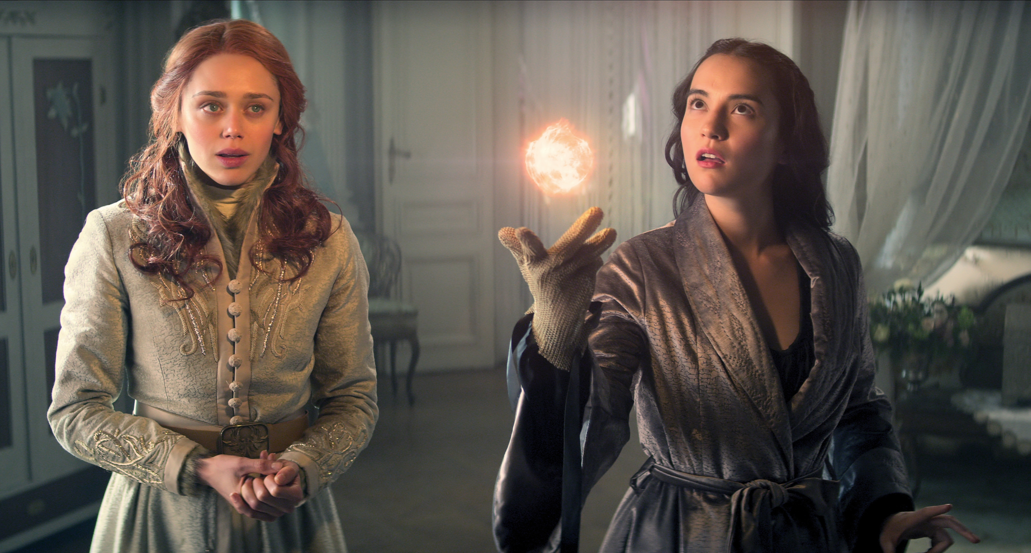 two women are standing next to each other and one is pointing at something