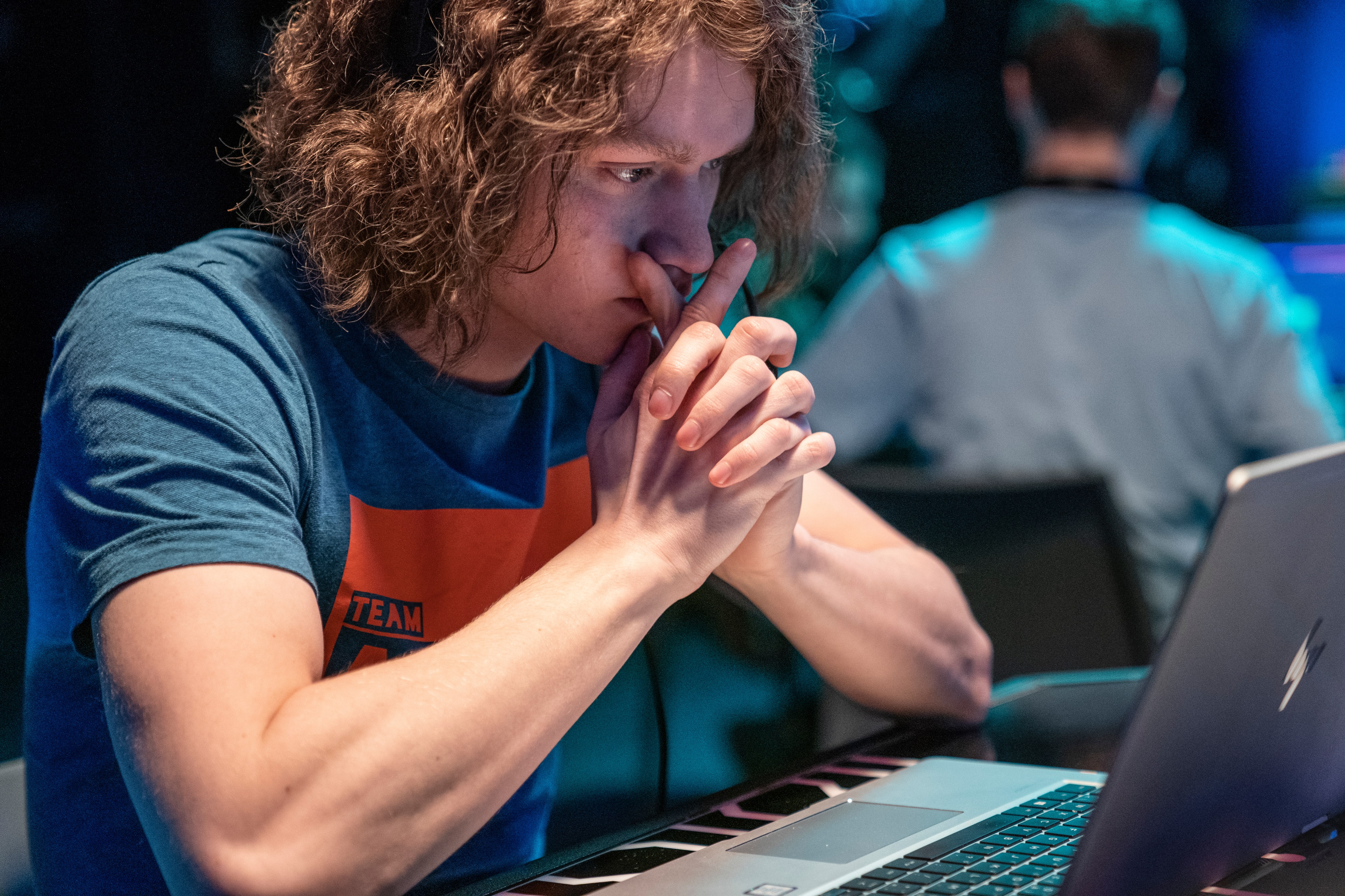 A man wearing a blue shirt with the word team on it.