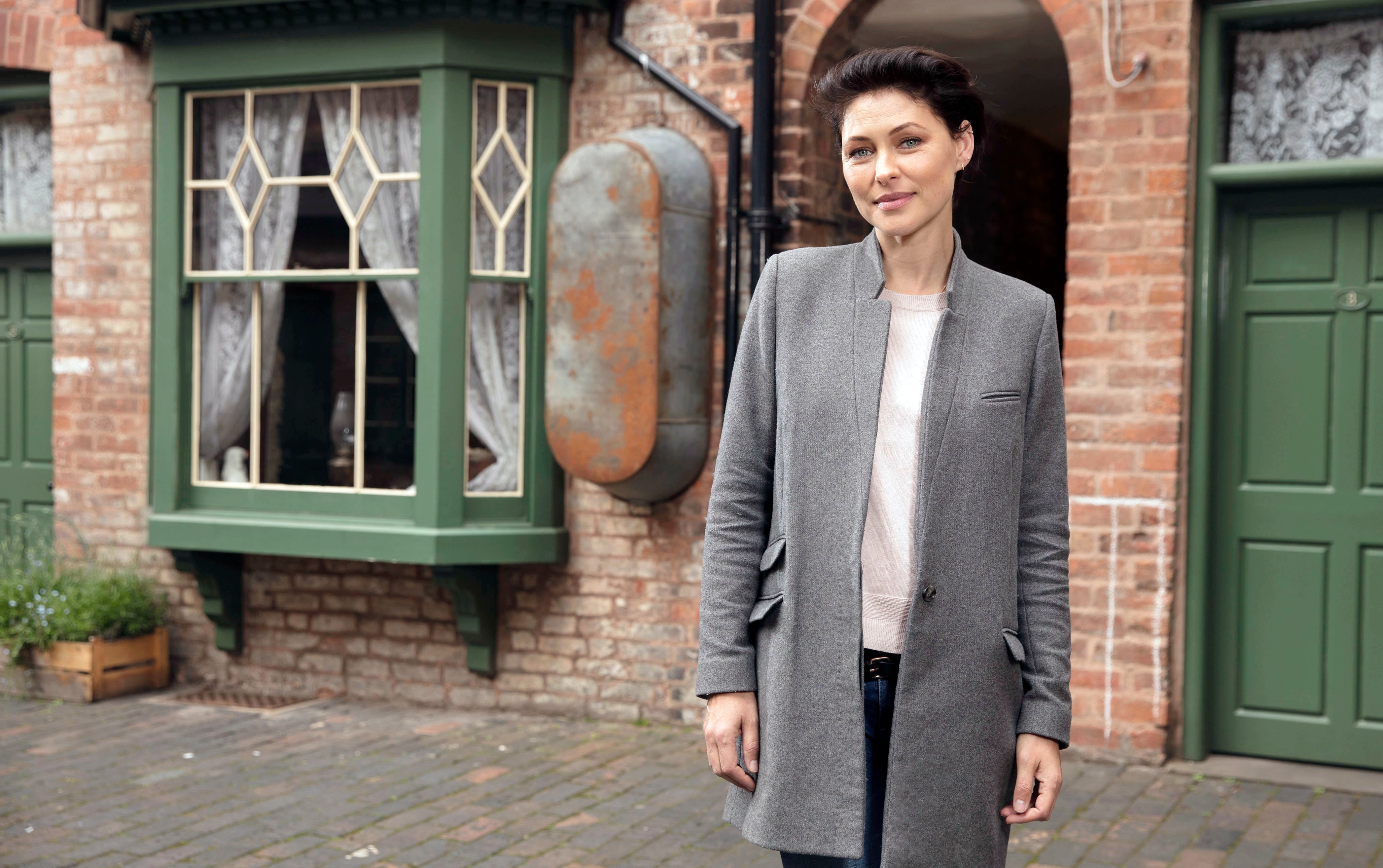 Emma Willis in a gray coat.