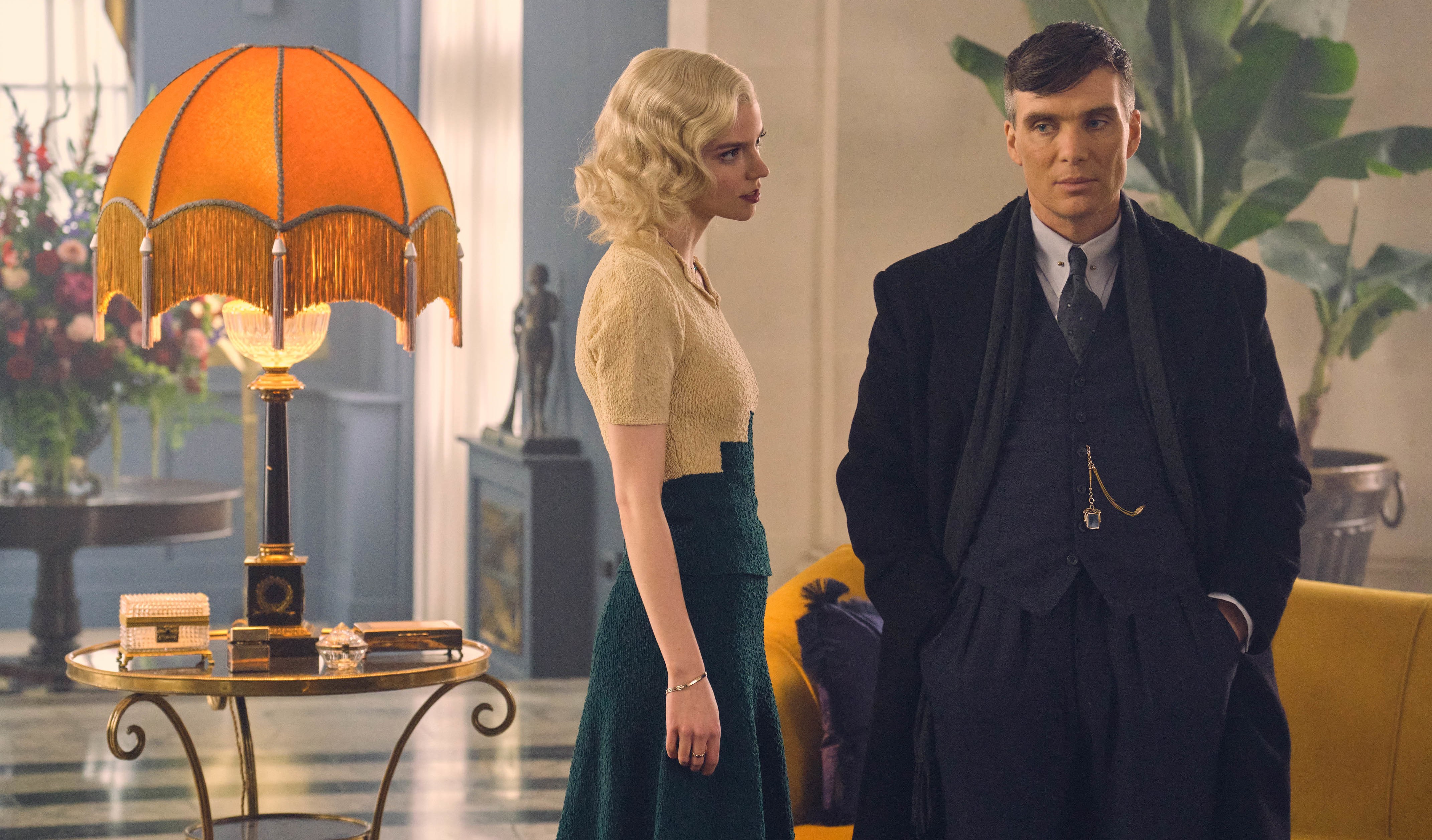 a man and a woman are standing next to each other in a living room