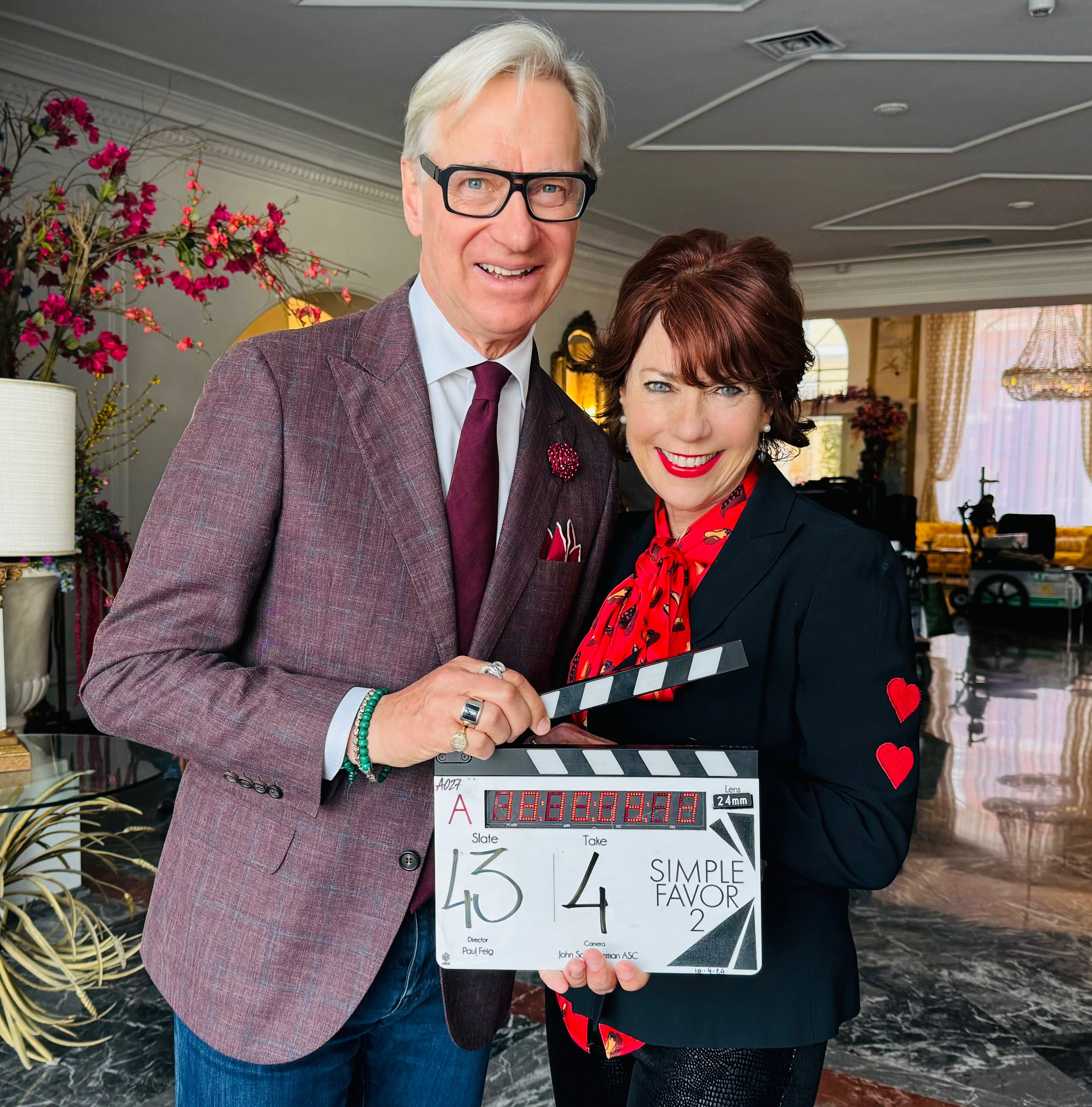 Kathy Lette and Paul Feig holding a clapperboard for Simple Favor 2.