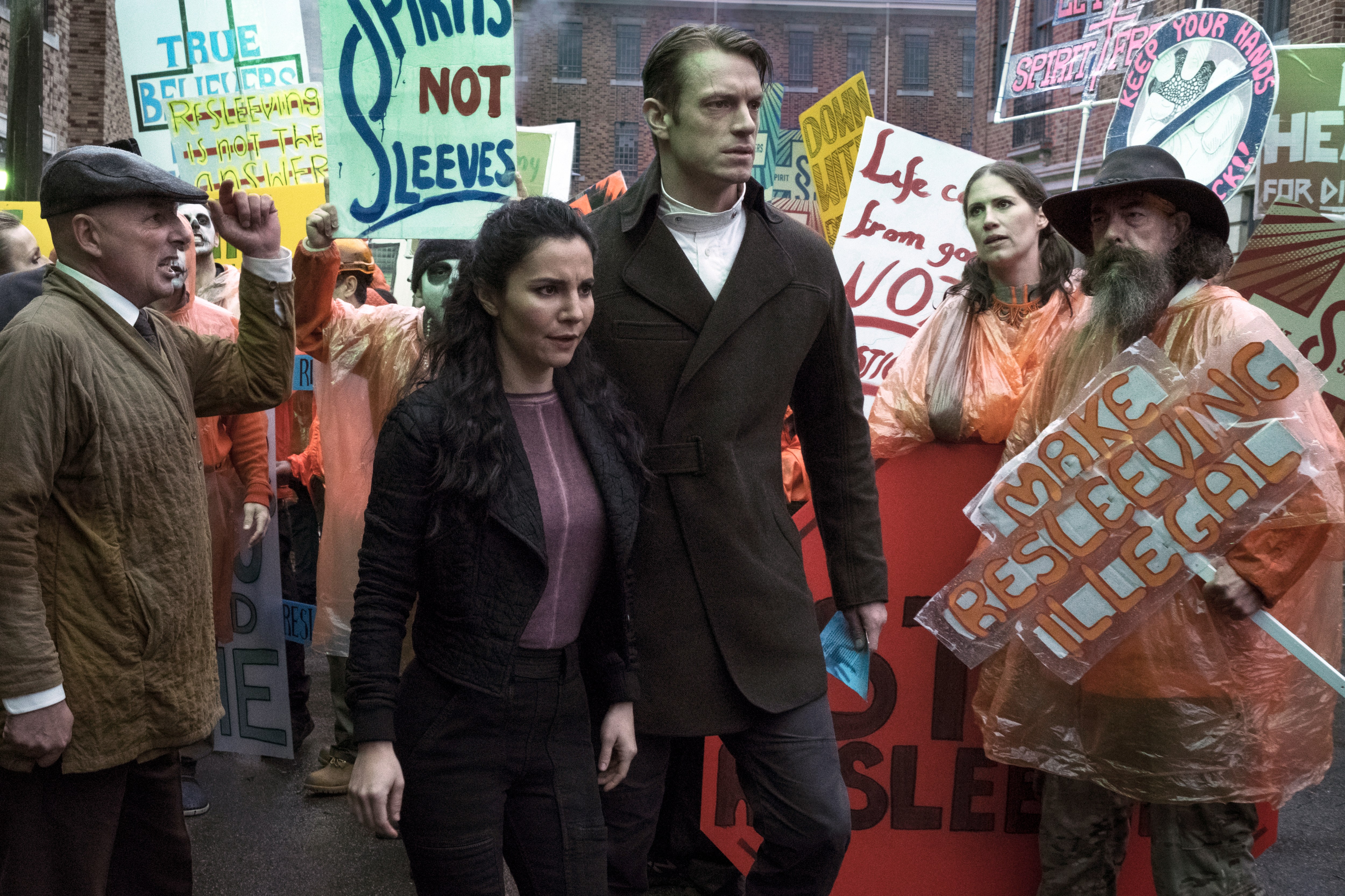 a group of people holding signs including one that says 