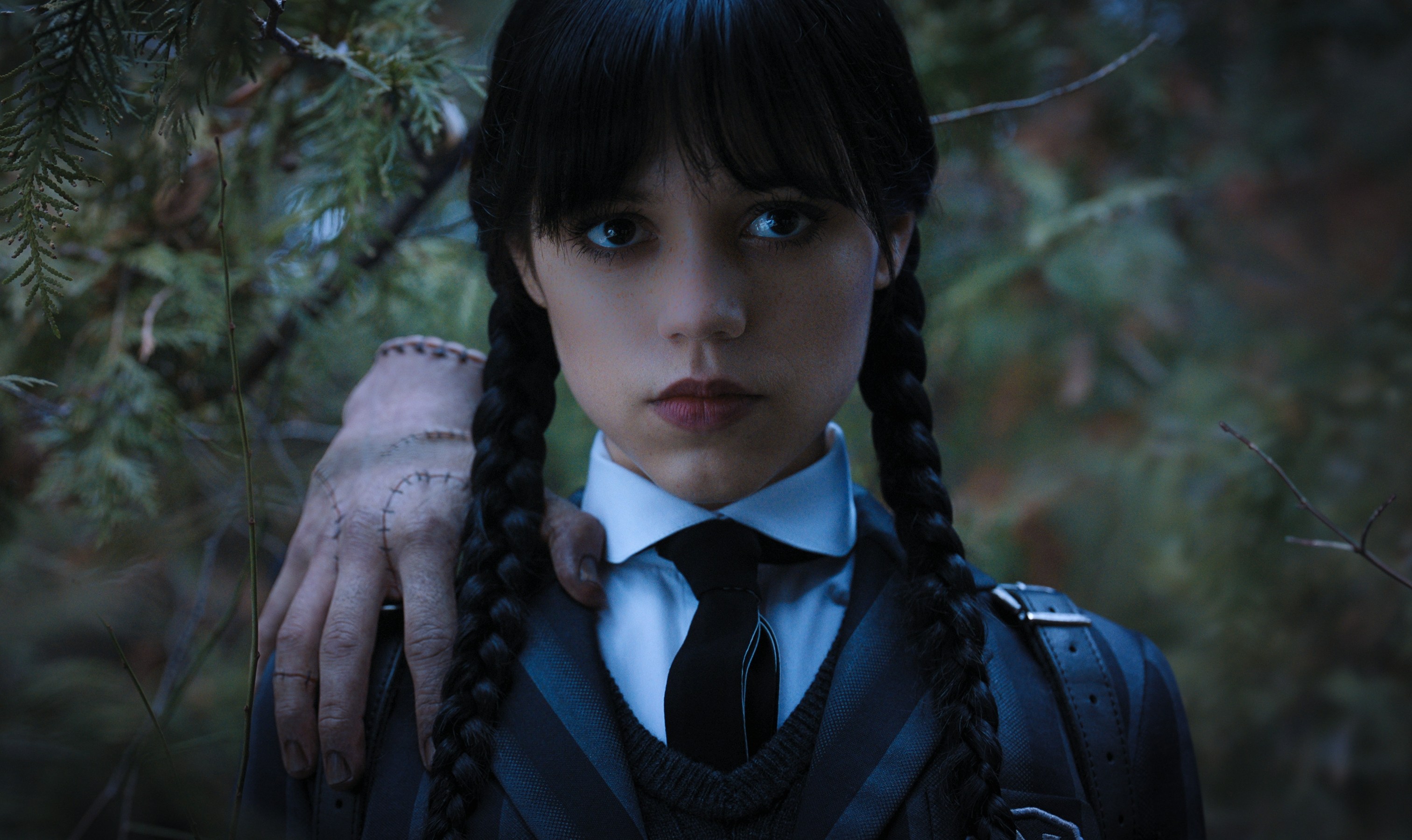 a girl with braids has a hand on her shoulder