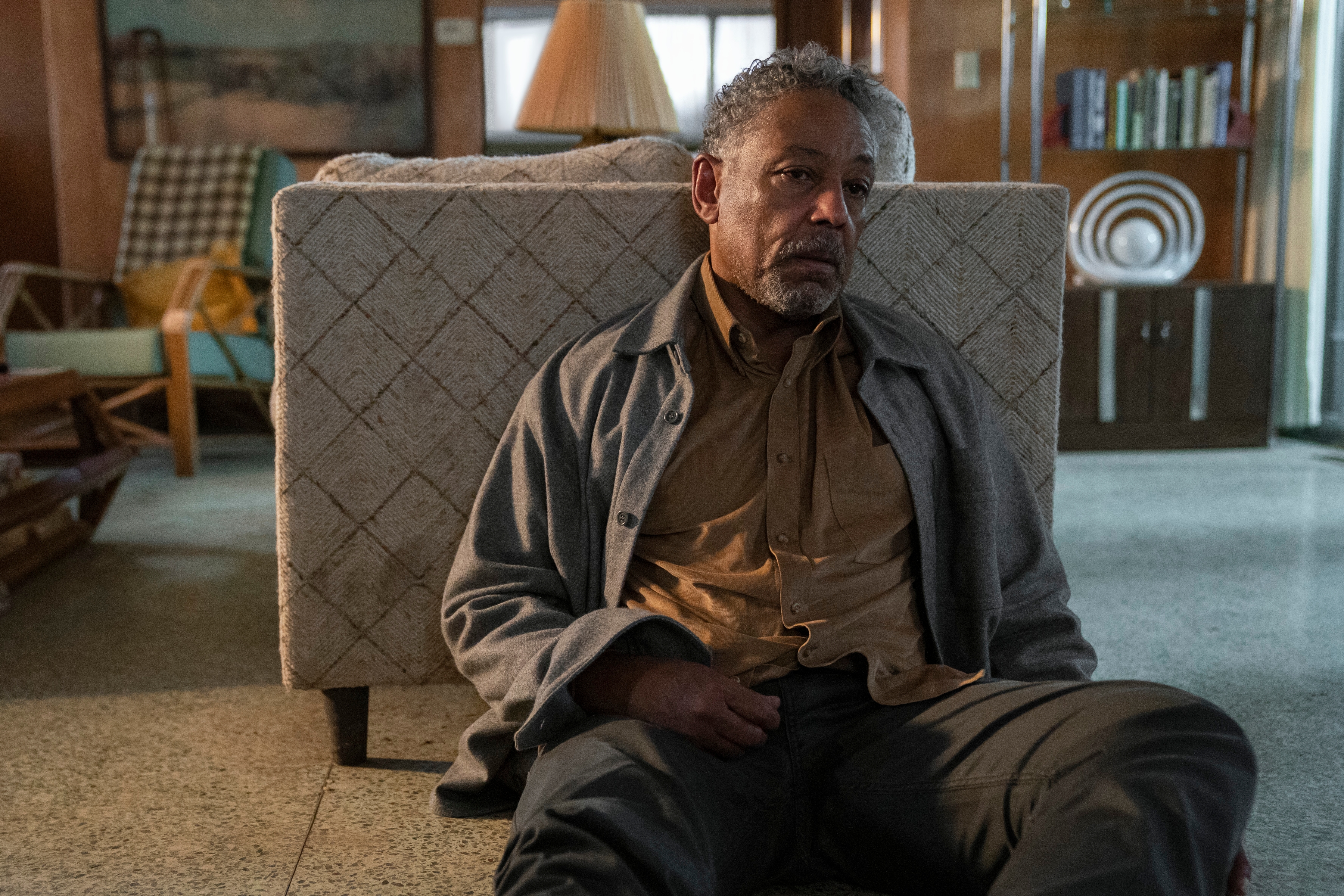 a man sits in a chair in a living room