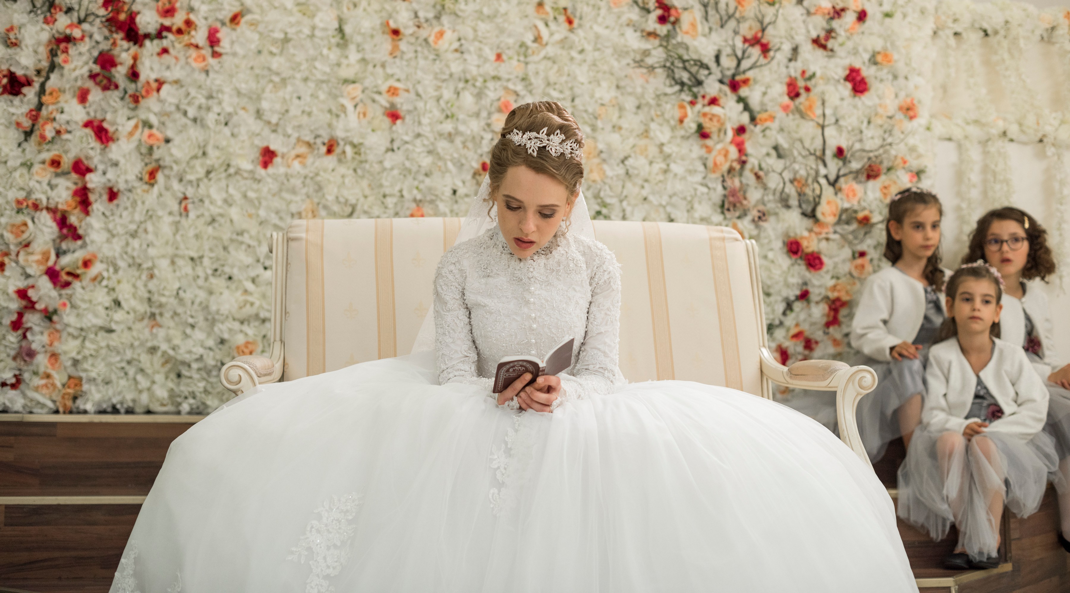 a woman in a wedding dress is reading a book